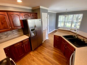 A kitchen with wooden floors and stainless steel appliances.