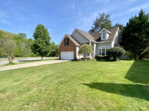 A large house with a driveway and lots of grass.