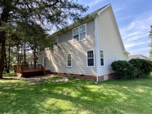 A house with a deck in the back yard