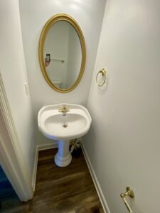 A bathroom with a sink and mirror in it