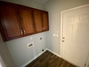 A room with a door and cabinets in it