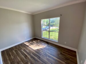 A room with a window and wooden floors