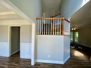 A view of the inside of a house with wood floors.