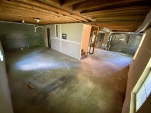 A view of the inside of a room with concrete floors.