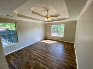 A room with wood floors and ceiling fan.