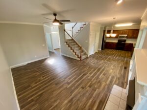 A room with hard wood floors and a ceiling fan.