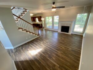 A living room with hard wood floors and fireplace.