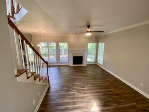 A living room with hard wood floors and a fireplace.