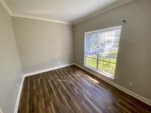 A room with wood floors and a window.