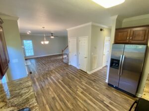 A kitchen with wood floors and stainless steel appliances.