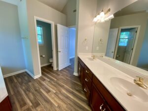 A bathroom with two sinks and a large mirror.