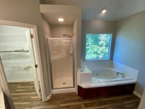 A bathroom with a tub and shower in it