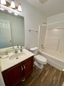 A bathroom with a sink, toilet and bathtub.