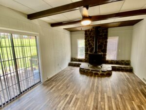 A room with wood floors and a fireplace.