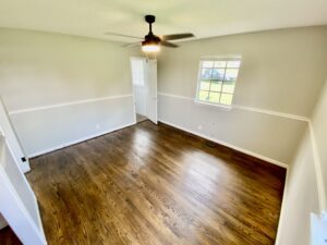 A room with wood floors and white walls.