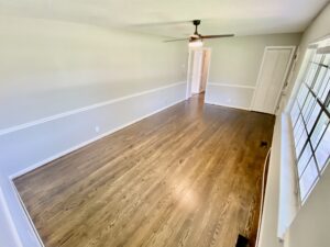 A room with wood floors and white walls.