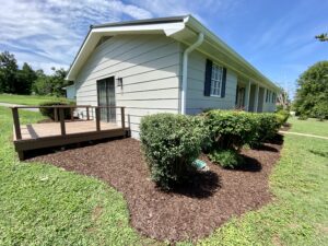 A house with bushes and trees in the yard