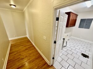 A room with wood floors and white walls.