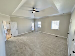 A room with white walls and ceiling fan.