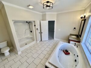 A bathroom with a large tub and walk in shower.