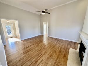 A room with hard wood floors and a ceiling fan.