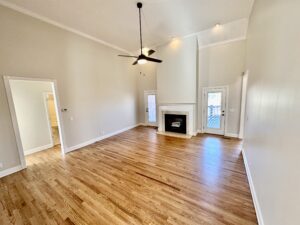 A living room with hard wood floors and a fireplace.