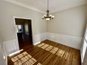 A room with hard wood floors and white walls.