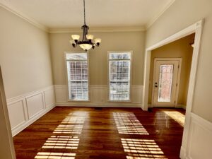 A room with two windows and a door.