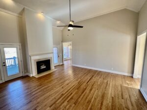 A living room with hard wood floors and fireplace.