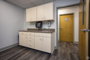 A room with a sink and cabinets in it