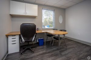 A room with two desks and chairs in it