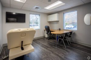 A room with a desk and chairs in it