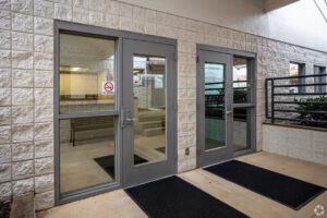 A building with two doors and a black door mat.