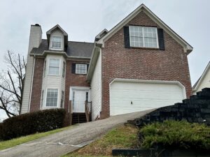 A house with two garage doors and a driveway.