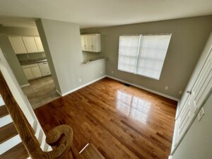 A room with wood floors and white walls.