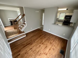 A living room with hard wood floors and a stove.