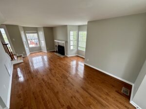 A living room with hard wood floors and fireplace.