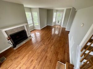 A living room with hard wood floors and fireplace.