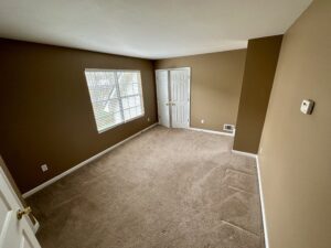 A room with brown walls and carpet.