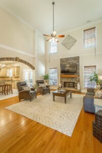 A living room with a fireplace and a large window.