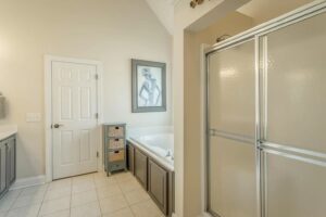 A bathroom with a tub, shower and sink.