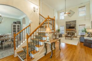 A living room with wooden floors and stairs