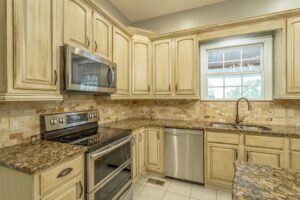 A kitchen with white cabinets and stainless steel appliances.