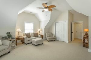 A living room with two couches and a ceiling fan.