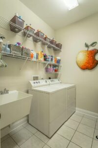 A laundry room with a sink and washer.