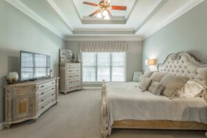 A bedroom with two beds and a tv in the corner.