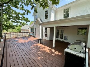 A large deck with a grill and bbq in it