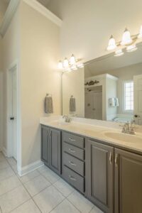 A bathroom with two sinks and a large mirror.