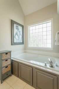 A bathroom with a tub and a window.