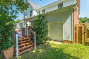 A house with stairs leading to the garage.